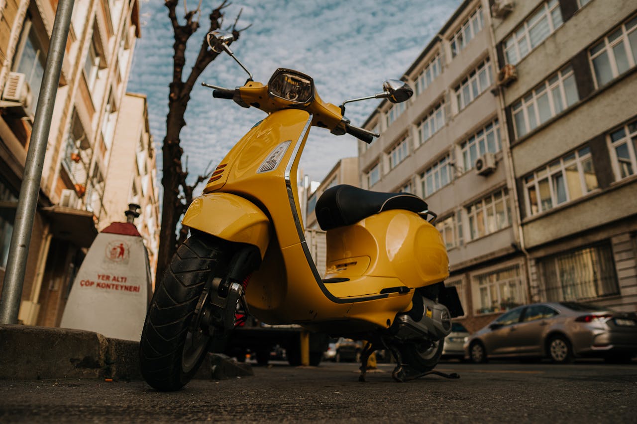 A vibrant yellow scooter parked on a city street in Istanbul, Turkey.